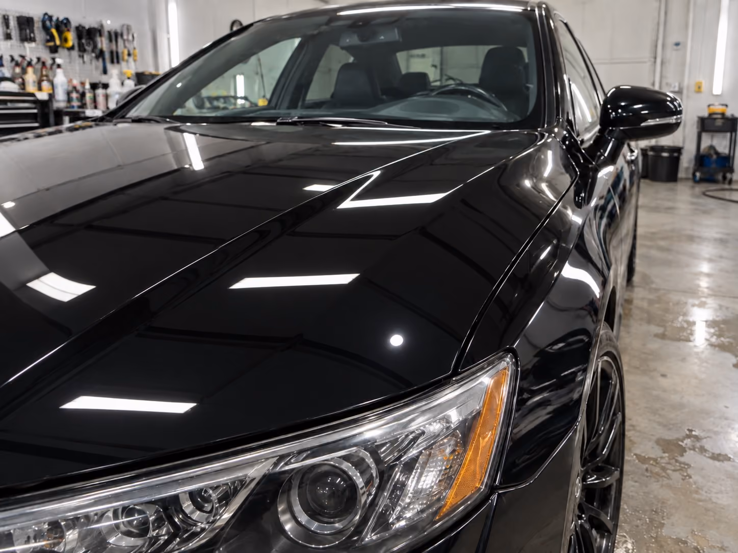 The same car panel after paint correction, with swirl marks removed